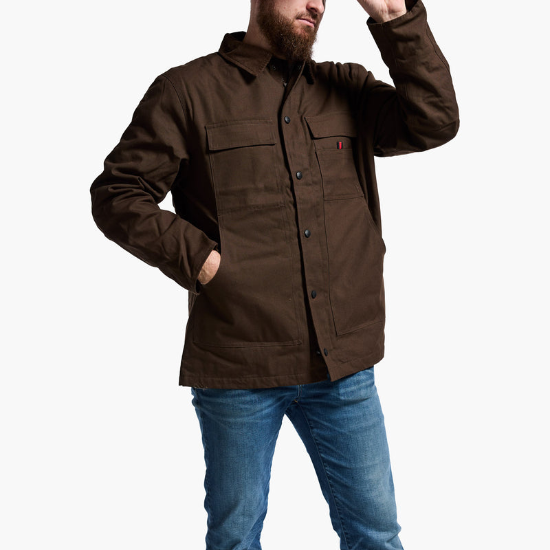 Man wearing a brown jacket with a red label on a white background