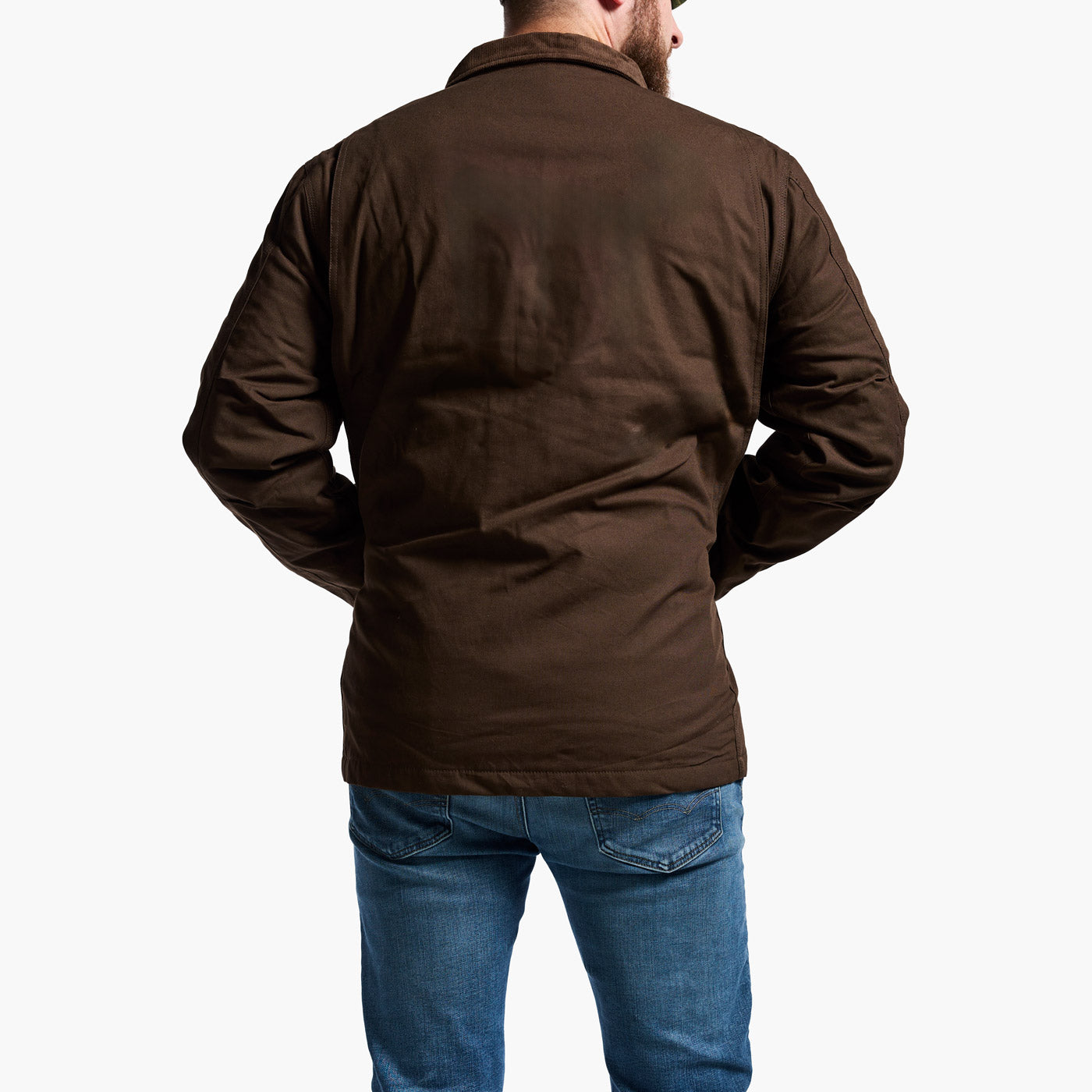 Man wearing a brown jacket and blue jeans on a white background
