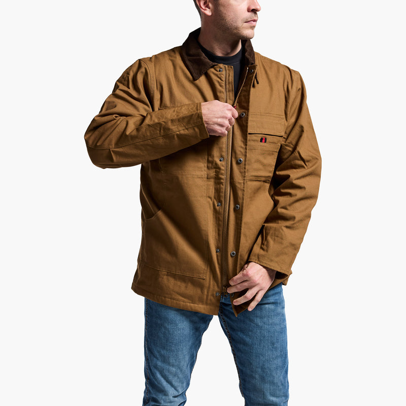 Man wearing a brown jacket and blue jeans on a white background