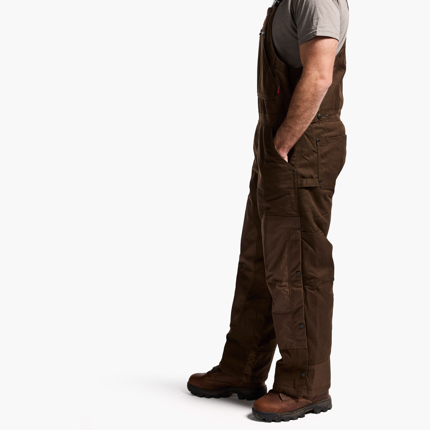 Brown overalls worn by a person on a white background