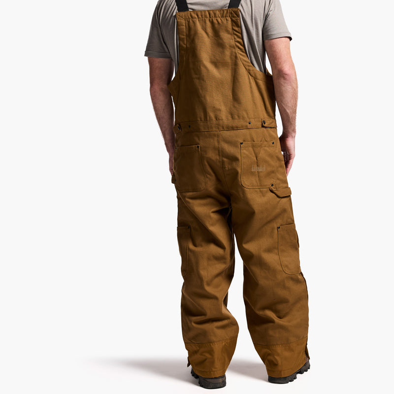 Brown overalls worn by a person on a white background