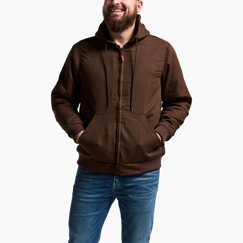 Man wearing a brown hoodie and blue jeans on a white background