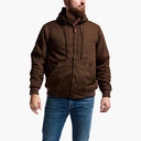 Man wearing a brown hooded jacket and blue jeans on a white background