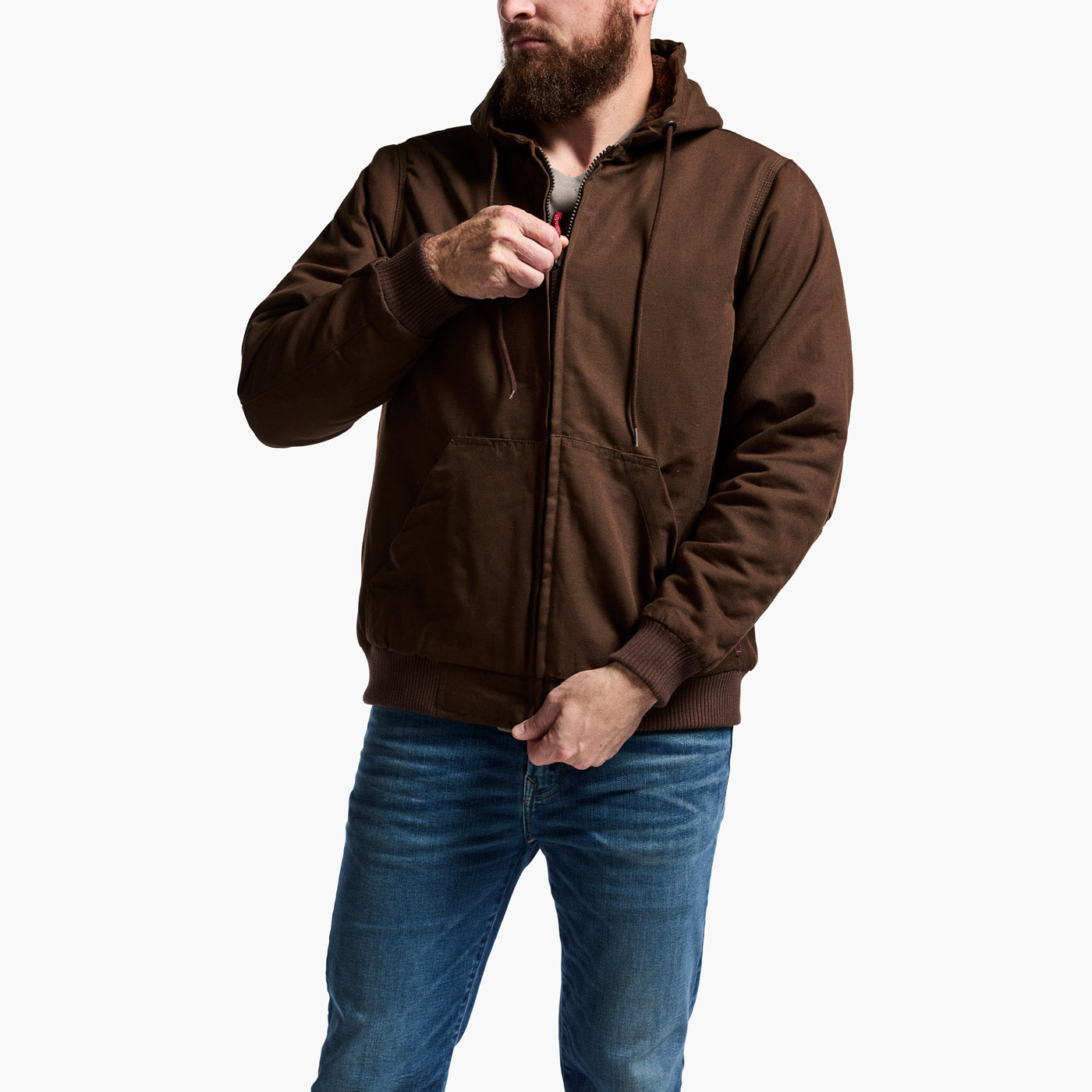 Man wearing a brown hoodie and blue jeans on a white background