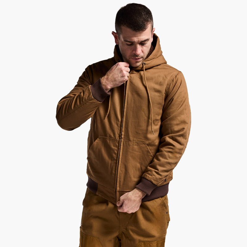 Man wearing a brown hoodie and pants on a white background