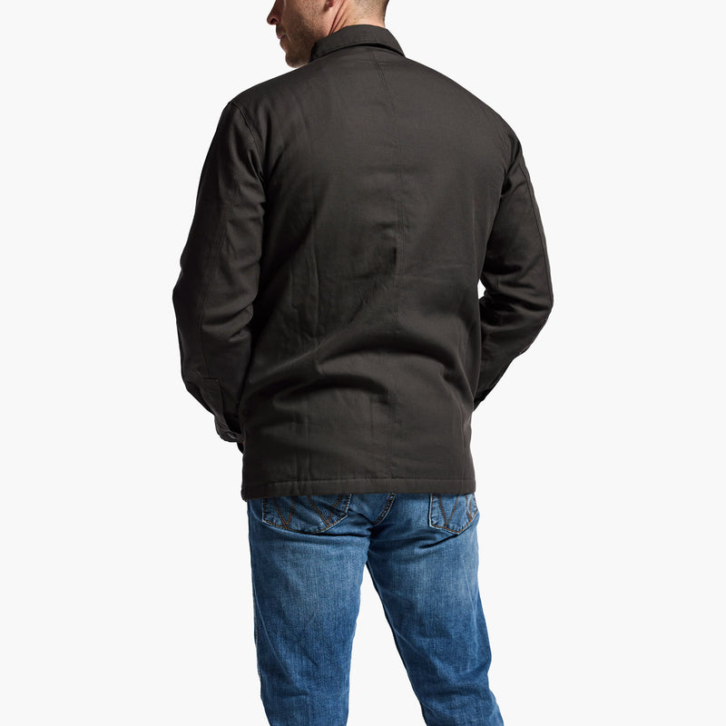 Person wearing a black jacket and blue jeans on a white background