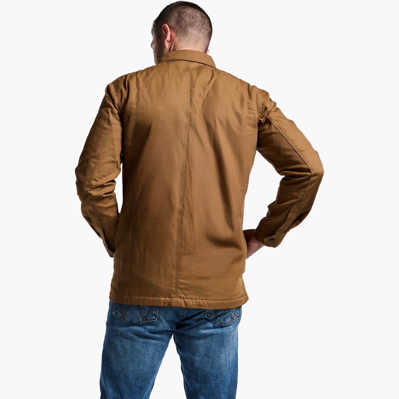 Man wearing a brown jacket and blue jeans on a white background