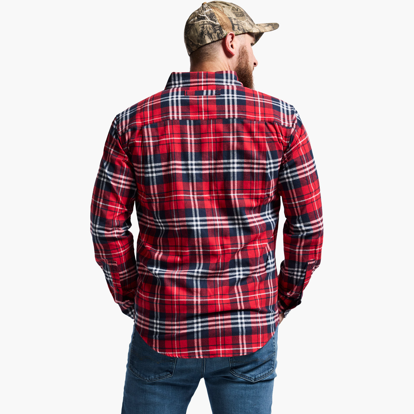 Man wearing a red and black plaid shirt with a camouflage cap on a white background