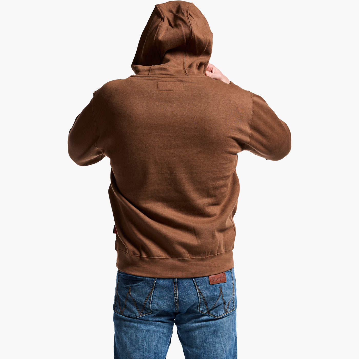 Person wearing a brown hoodie and blue jeans on a white background