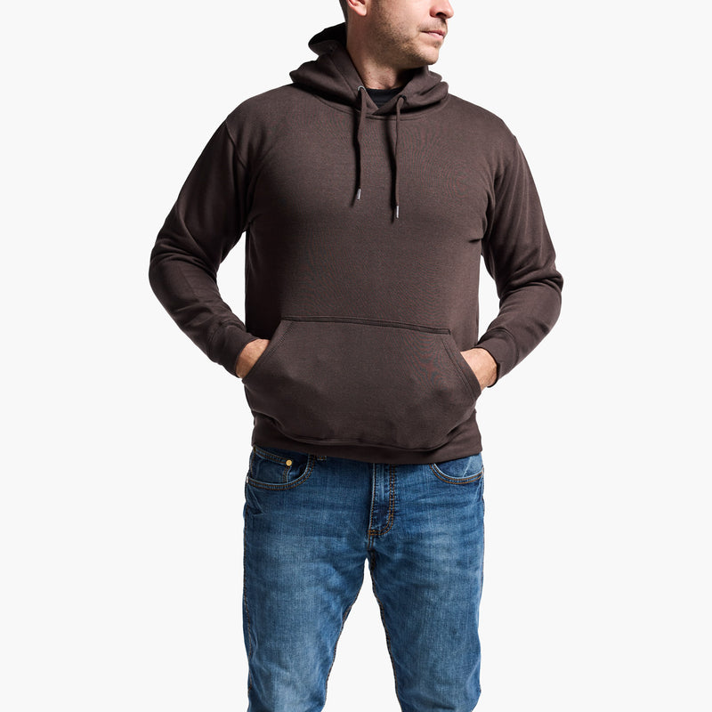 Man wearing a brown hoodie and blue jeans on a white background