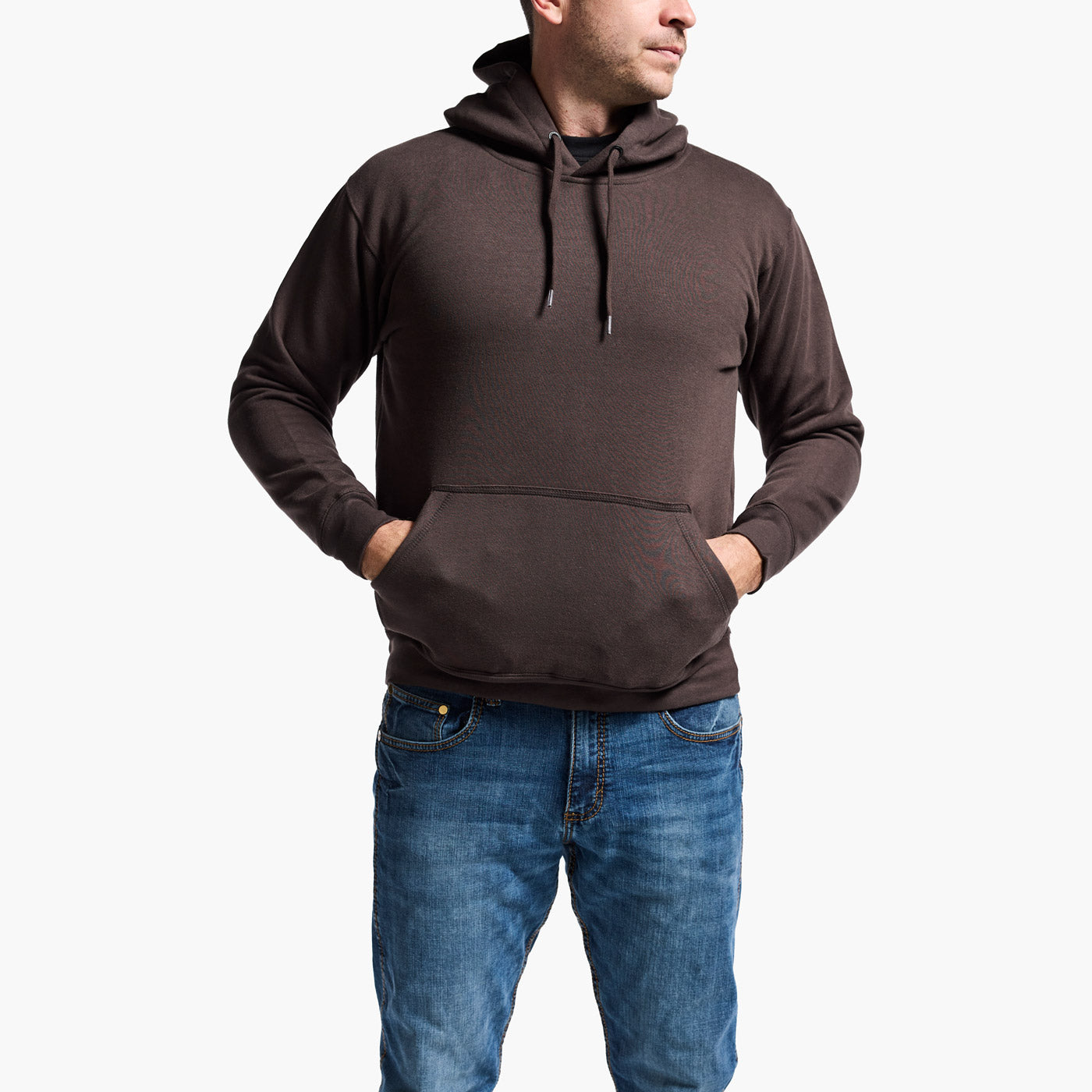 Man wearing a brown hoodie and blue jeans on a white background