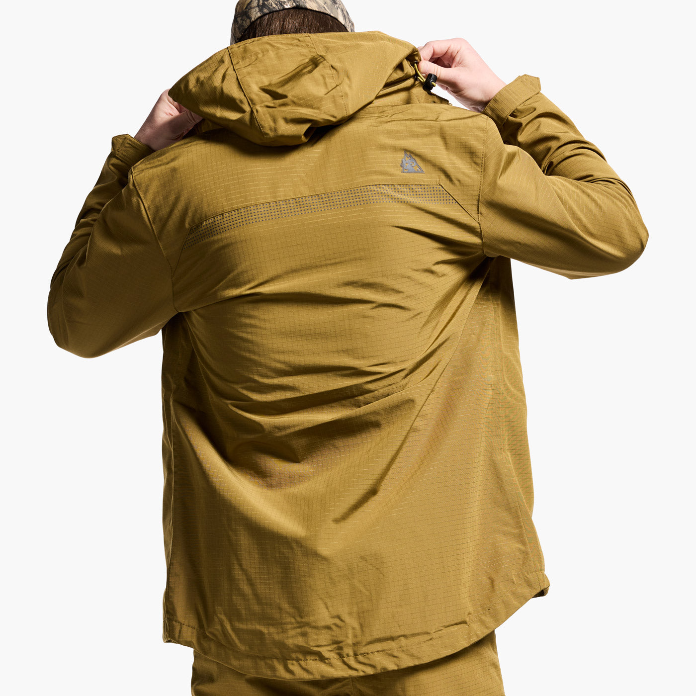 Person wearing a mustard yellow jacket on a white background