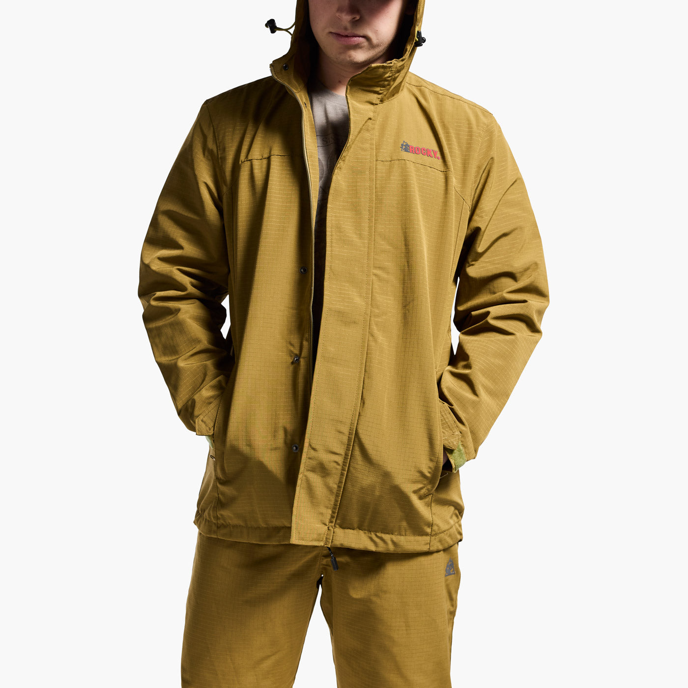 Person wearing a mustard yellow raincoat on a white background