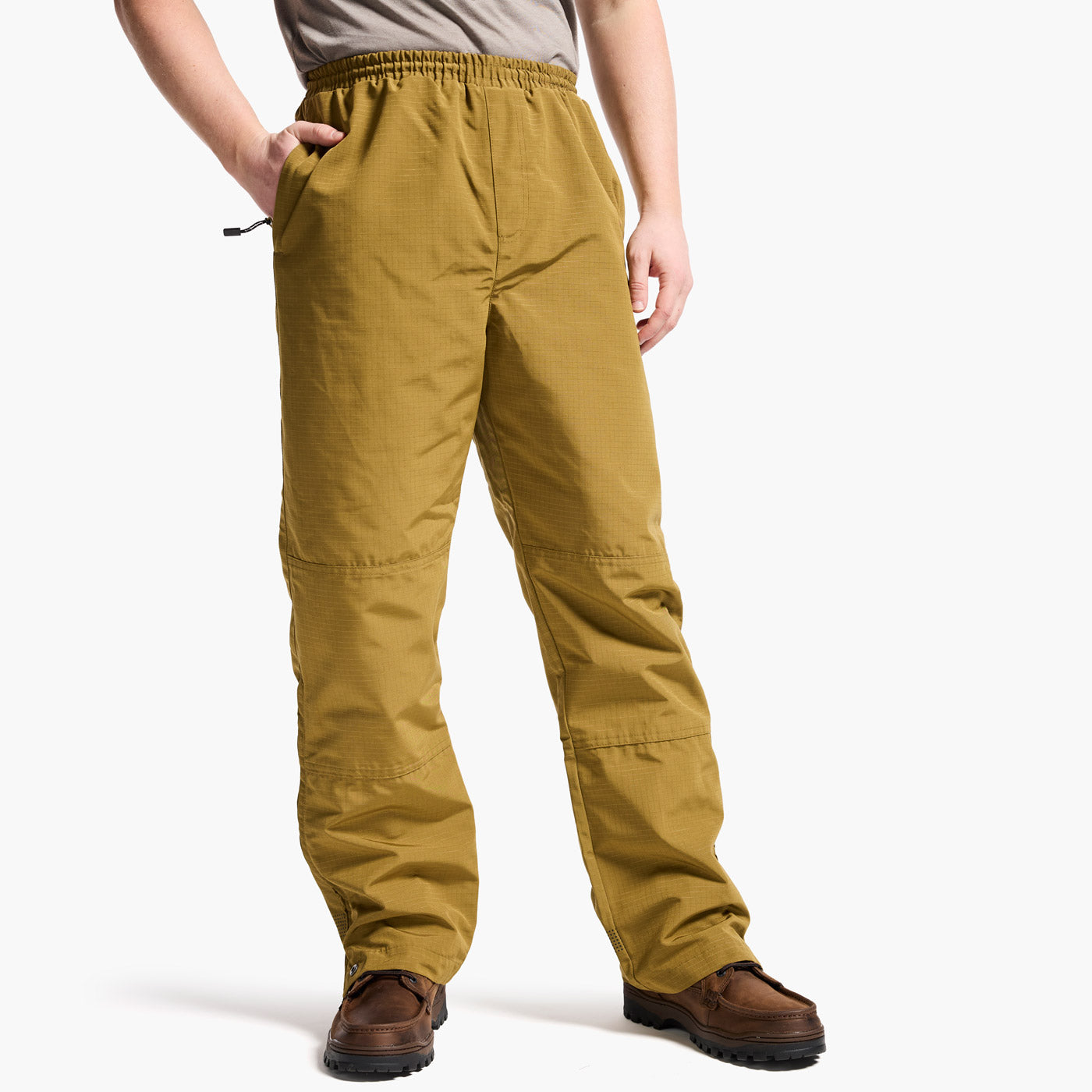 Person wearing mustard yellow pants on a white background