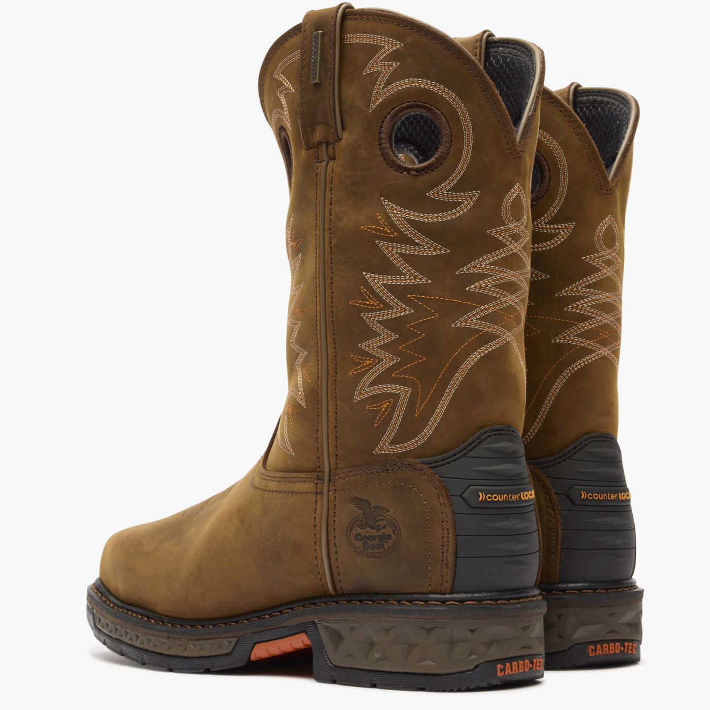 Pair of brown cowboy boots with intricate stitching on a white background