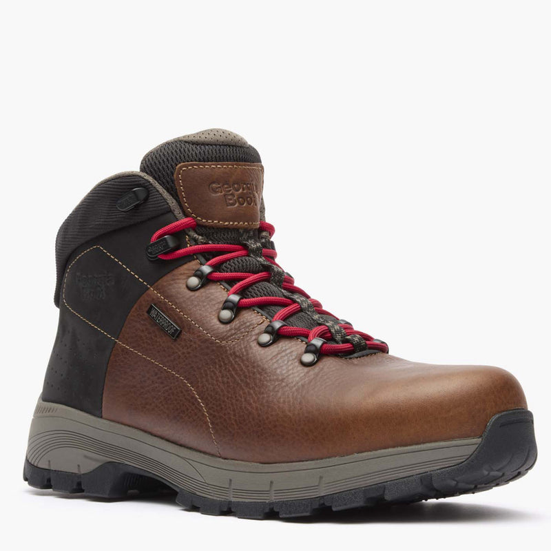 Brown hiking boot with red laces on a white background