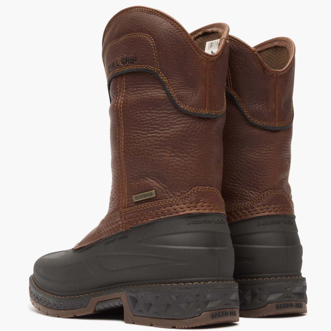 Pair of brown leather boots with black soles on a white background
