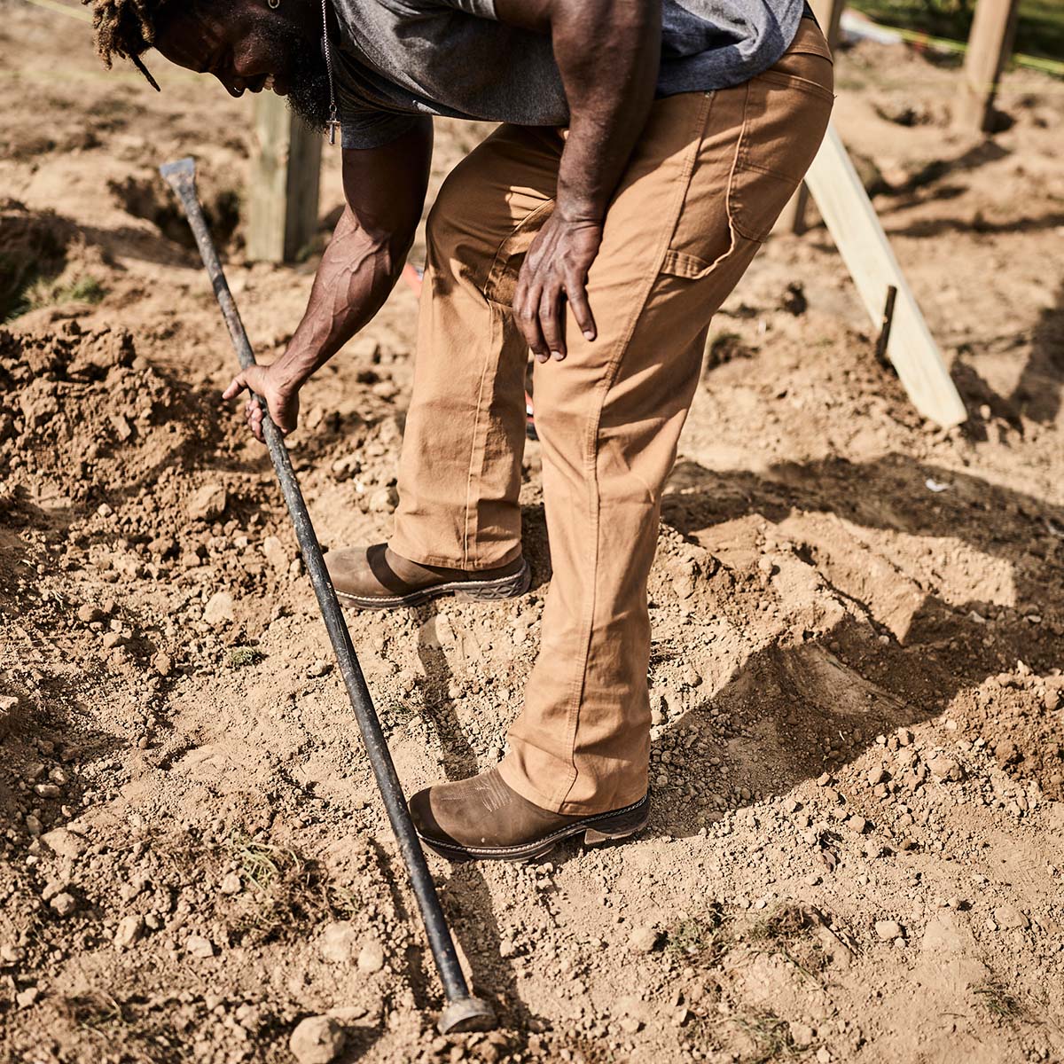 Person digging in the dirt with a shovel