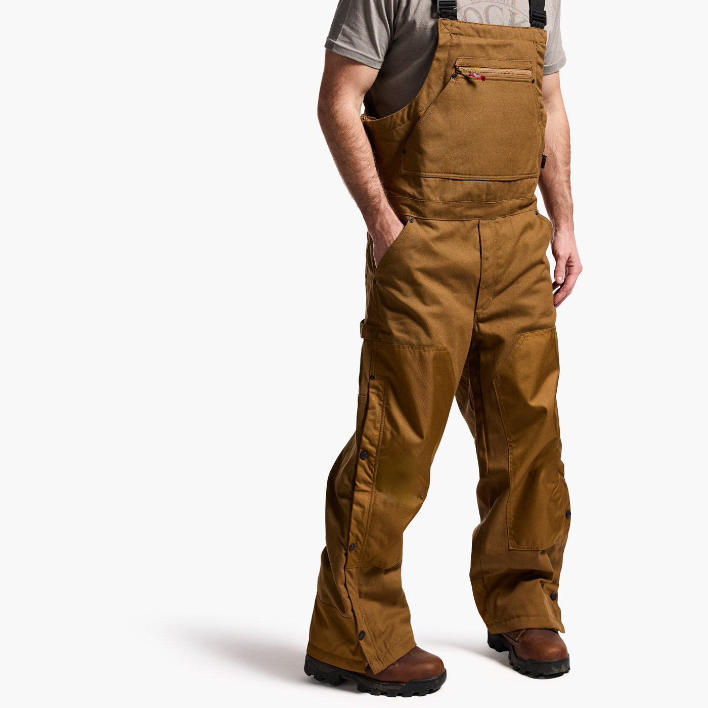 Person wearing brown work pants on a white background